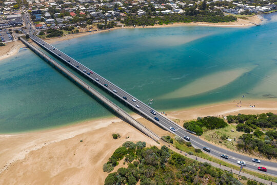 Aerial view of two bridges crossing a wide blue river