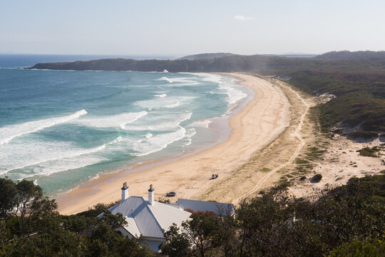 View from Sugar loaf point over lighthouse beach where people are four wheel driving