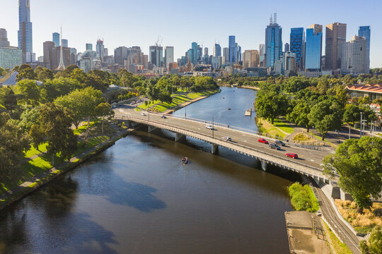 Aerial view of traffic crossing a bridge over an inner city river