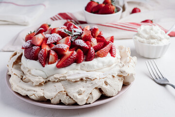 Delicious Pavlova cake dessert with fresh strawberry. White and red dessert
