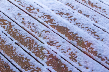 Full frame abstract texture background of a snow covered cedar wood deck floor in winter weather