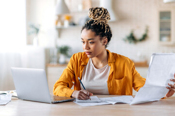 Work from home. Concentrated clever african american woman, student or designer, wearing stylish...