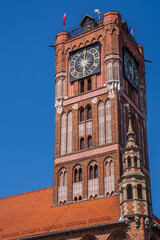 Low angle shot of the Clock Tower of Ratusz building in Torun, Poland