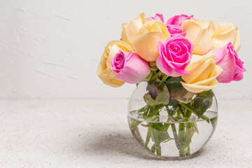 Bouquet of fresh multicolored roses in a vase