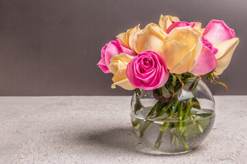 Bouquet of fresh multicolored roses in a vase