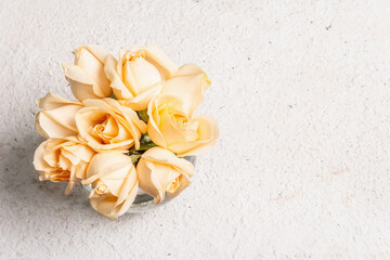 Bouquet of fresh beige roses in a vase