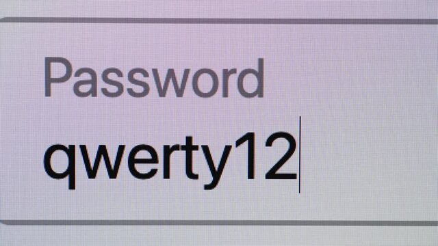 Entering weak and strong passwords in a password box on a computer screen, close up	
