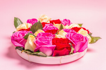 Obraz na płótnie Canvas Composition of fresh multicolored roses on ceramic stand