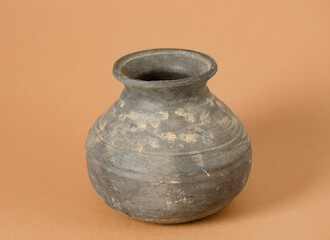 Aged Clay Pot with Weathered Texture on Warm Ochre Background