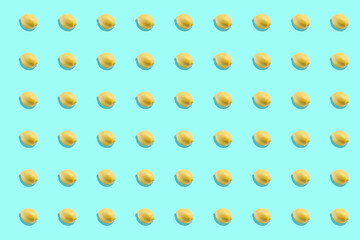 Yellow lemons pattern on light blue background. Vertical