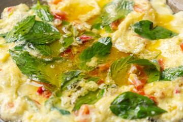 Making Thai omelette in a pan. Selective focus. Locally known as Kai Chiao.