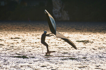 Windsurfer surfing the wind on waves In Garda Lake, riders surfing at high speed on Lake Garda,...