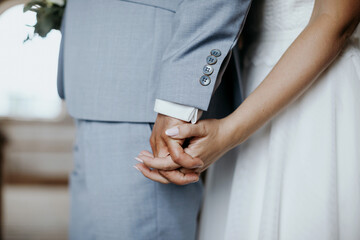 Bride and groom holding each other hands on the wedding day
