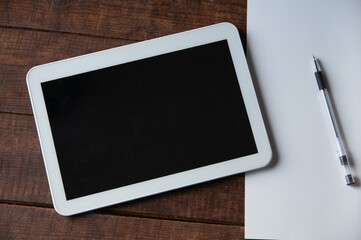 Modern office workplace with tablet pc on the table. On the table is a tablet computer