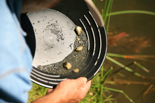 gold panning, man striking it rich by finding the mother lode or at least a nugget or two.