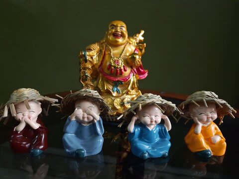 Laughing Buddha and little monks
