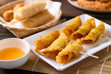 Asian deep fried crispy wonton stuffed with minced pork, quail egg and shrimp eating with chili sauce