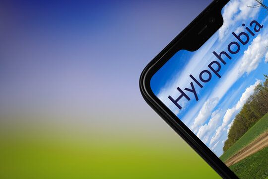 Hylophobia text on phone screen with forest blurred background