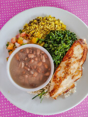 brazilian tipical rice and beans dish top view pink background 