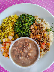 brazilian tipical rice and beans vegan dish top view pink background 