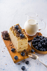 cake with blueberries and milk on a white table