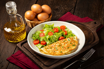 Omelet with cheese and lettuce and tomato salad.