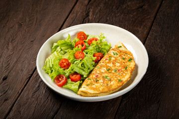 Omelet with cheese and lettuce and tomato salad.