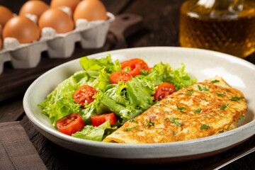 Omelet with cheese and lettuce and tomato salad.