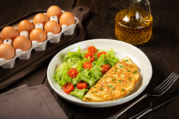 Omelet with cheese and lettuce and tomato salad.