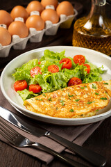 Omelet with cheese and lettuce and tomato salad.