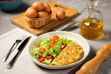 Omelet with cheese and lettuce and tomato salad.