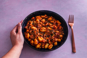 vegan potato gnocchi with red pesto cannellini beans and spinach, healthy plant-based food