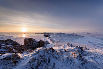 View above big beautiful frozen lake and mountain in winter, Baikal lake, Russia
