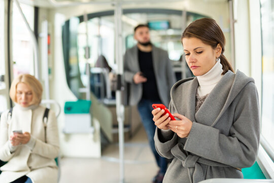 Woman with smartphone in bus. High quality photo