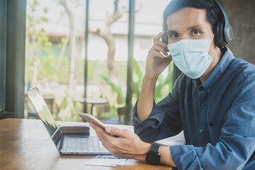 Man wear facemask working laptop  in cafe , People using phone , Asian man use headphone listening music