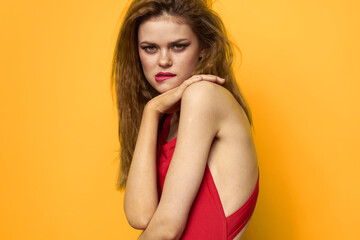 Pretty woman wavy hair red tank top fashion lifestyle cosmetics yellow background