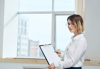 Business woman but we are with a white sheet of paper near the window