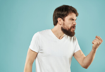 emotional man with beard on blue background gesturing with hands cropped view Copy Space