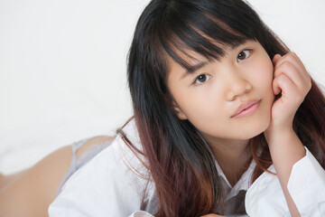 Beautiful and sexy Chinese woman wearing a white shirt isolated on a white background