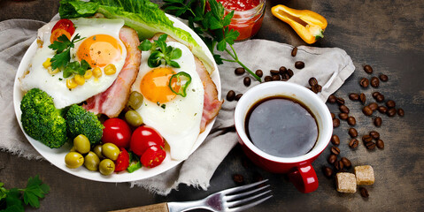 Fried eggs with vegetables on dark grey background