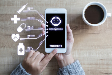 Hand using white smart phone telehealth with doctor and medical sign icon on top view. Telehealth concept.