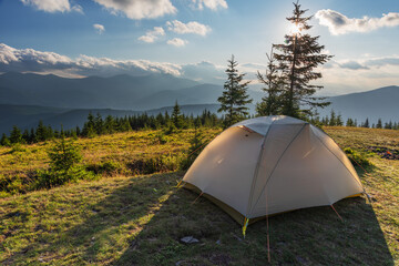Summer vacation in the mountains with a tourist tent with beautiful views around