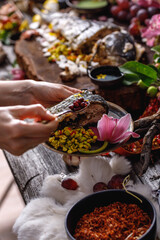 Still life in old masters style with fish, glass of wine, old dishes, fruits. The concept of a richly decorated table.