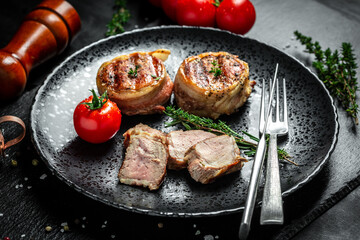 Healthy lean grilled medium-rare beef steak. beef tenderloin steak covered bacon. Food recipe background. Close up