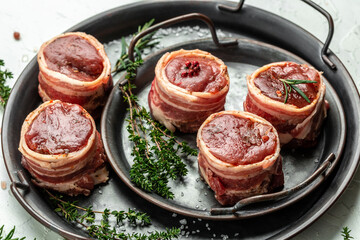 Raw fresh marbled meat Steak filet mignon. beef tenderloin steaks wrapped in bacon served on old meat tray. top view