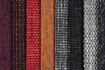 Multi-colored samples of woven textiles. Catalog and palette tone of Interior fabric for furniture, closeup.