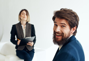 Fototapeta na wymiar and emotional man at job interview and business woman in suit in the background