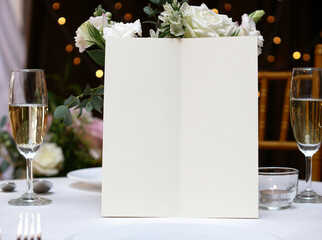Mockup white blank space card, for Menu, Flyer, greeting, invitation on wedding table setting background. with clipping path