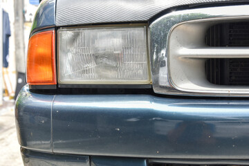 Damaged and blurred headlight surface as a result of weather condition and aging of a car
