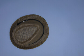 Beach and rustic straw hat on gray background.